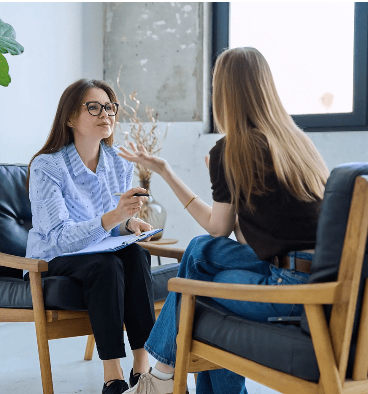 Two women talking in a counseling session.