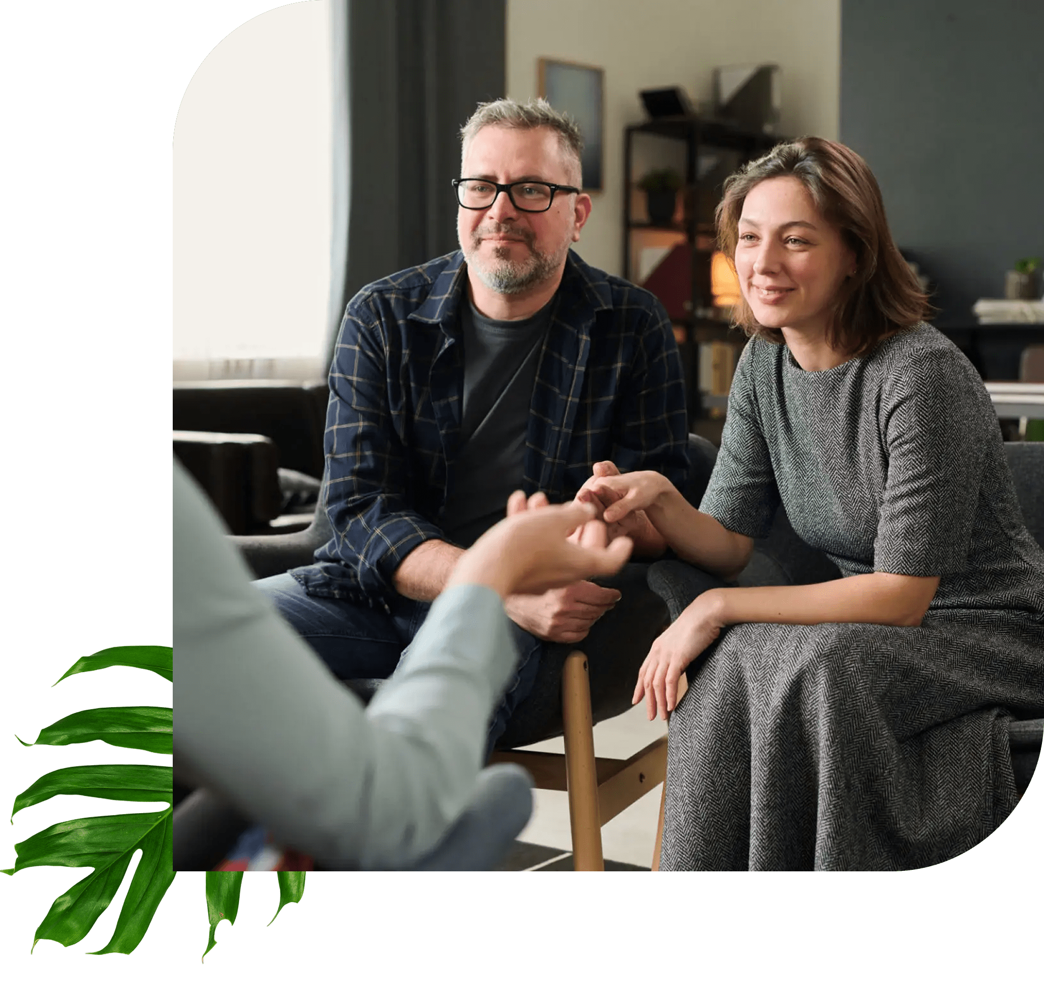 Couple holding hands in therapy session.