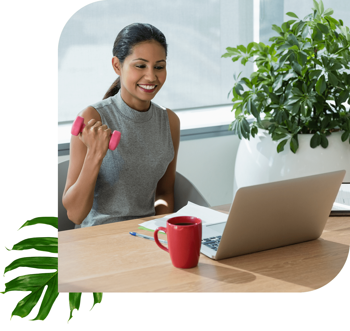 Woman exercising with dumbbell at desk.